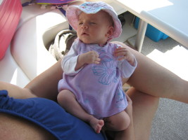 baby with sun hat on boat